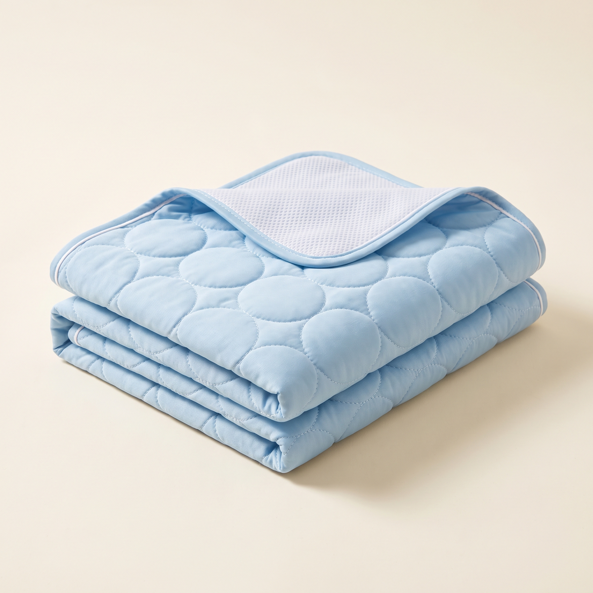 ChillHund Cooling Mat folded, showing the quilted ice-silk top and breathable mesh underside